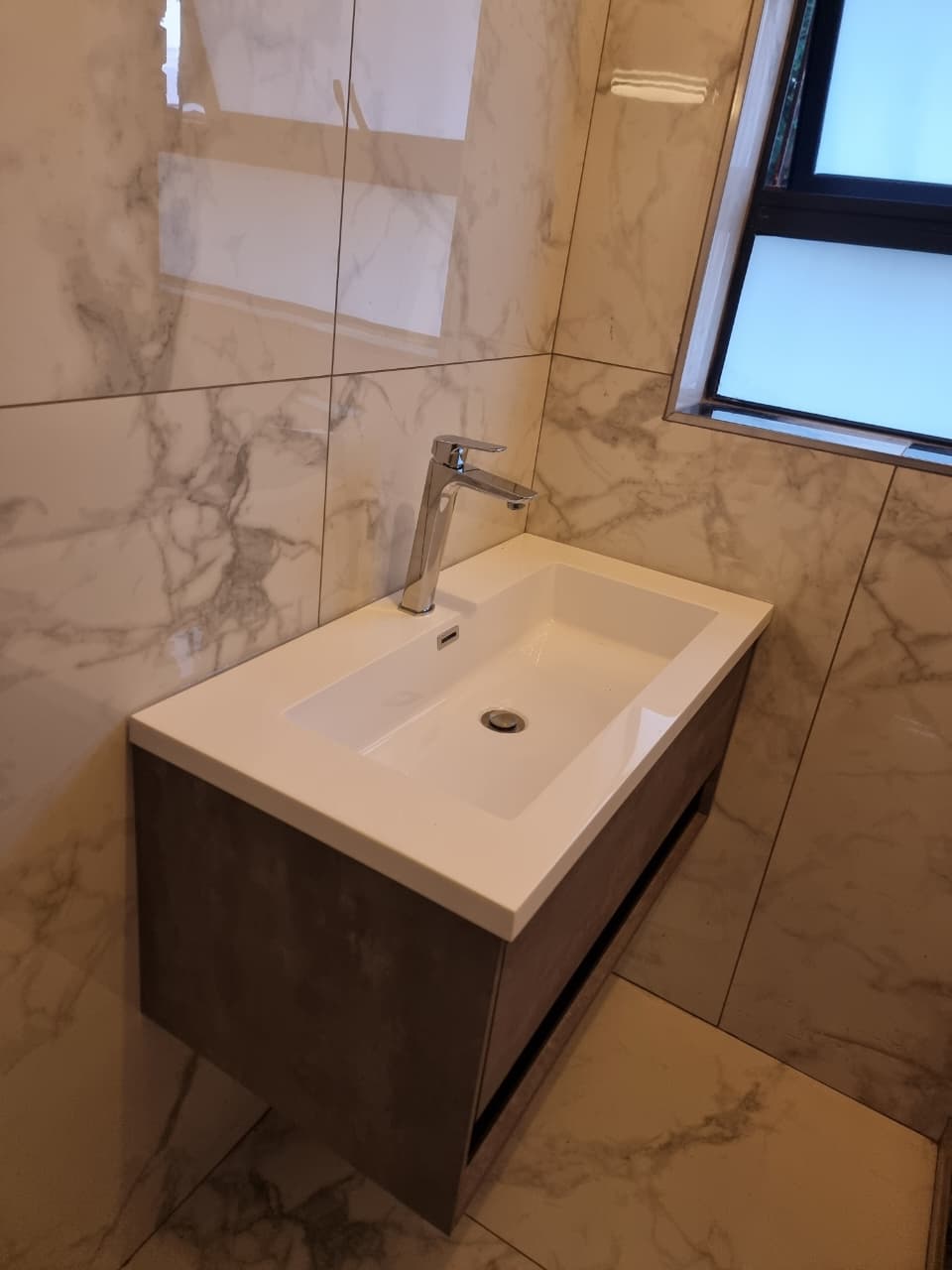 Wall-mounted bathroom vanity and basin installation