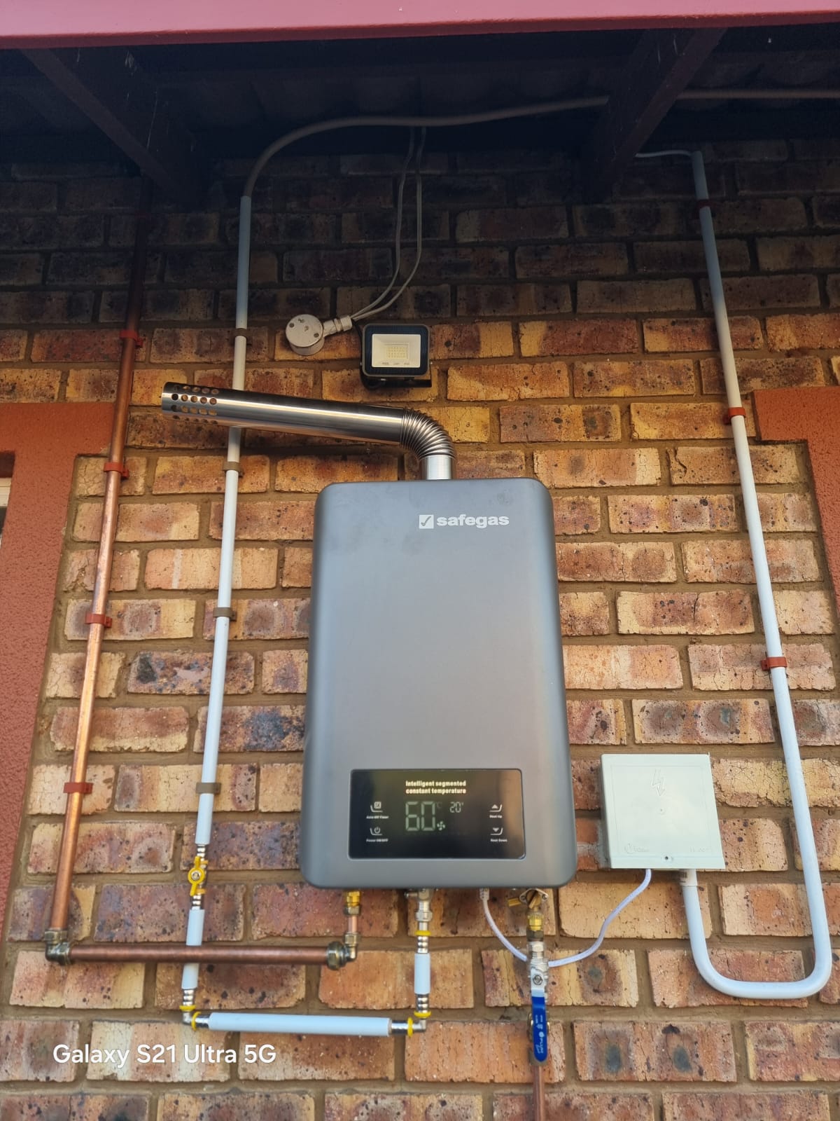 Gas tankless water heater installed on an exterior wall