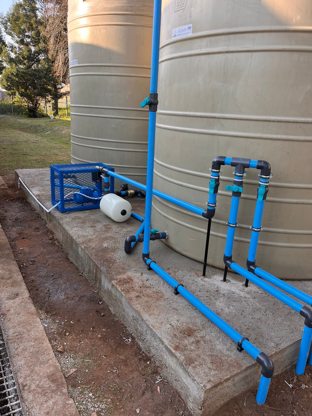 Close-up of tank pump plumbing and valves